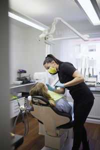 Female dentist with patient in office