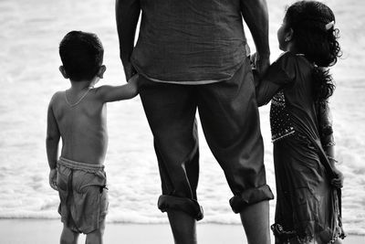 Rear view of father and son standing outdoors