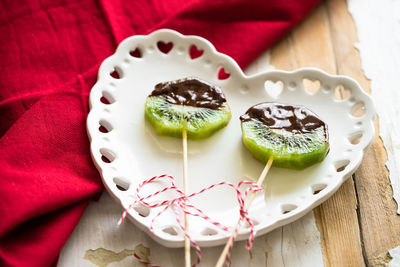 Kiwi slices with chocolate on heart shaped plate