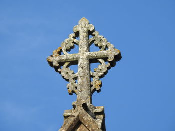 Low angle view of cross against clear blue sky