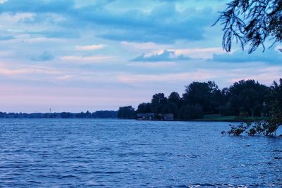 Scenic view of calm sea against cloudy sky