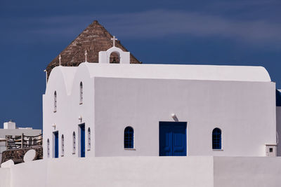 Saint nikolaos holy convent and a traditional wind mill in imerovigli village, santorini, greece