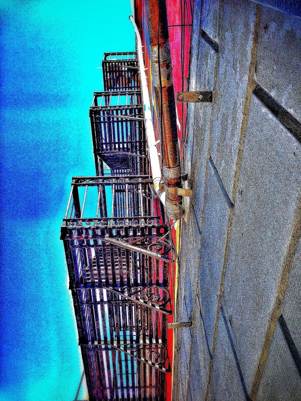 blue, built structure, architecture, sky, building exterior, low angle view, metal, outdoors, sunlight, auto post production filter, shadow, metallic, no people, railing, day, cloud - sky, cloud, protection, dusk, connection