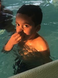 Portrait of boy swimming in pool