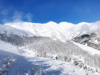 Scenic view of snow covered mountains against sky