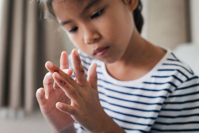 Fresh wound and blood from injured on child fingers after she has been an accident.