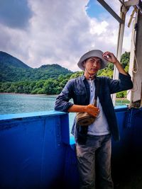 Full length of man standing on mountain against sky