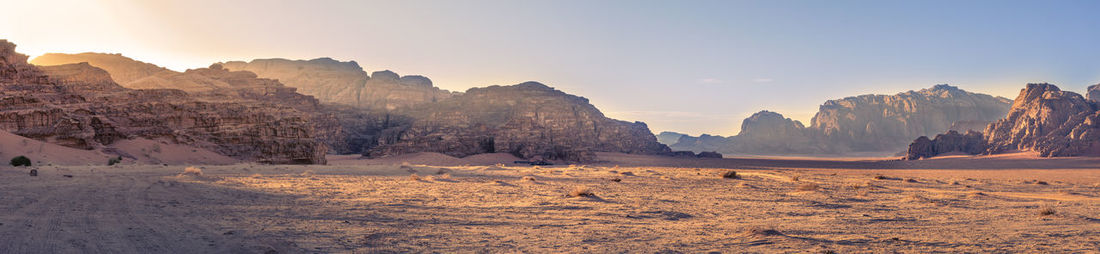 Panorama landscape shot of wadi rum desert in jordan during golden hour. travel and tourism.