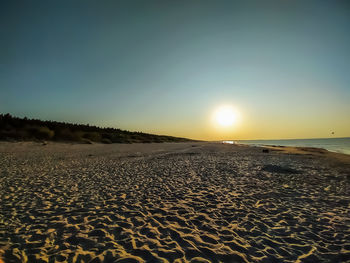 Scenic view of beach against sky during sunset