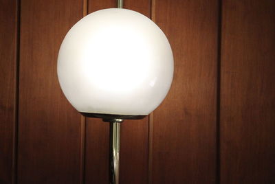 Close-up of light bulb on table