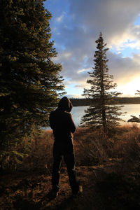 Rear view of woman standing on land against sky
