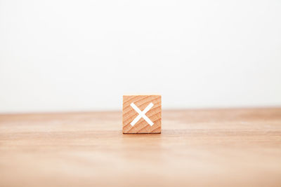 Close-up of wooden box on table against white background