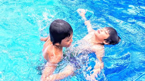 Friends swimming in pool