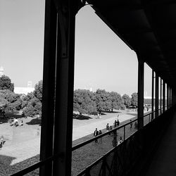 Bridge over river in city against clear sky