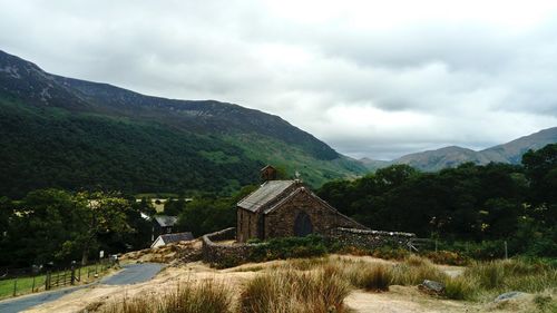 Scenic view of building and mountains against sky