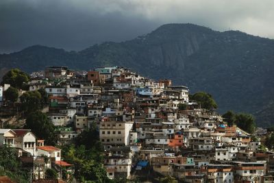 Buildings against mountains at dusk