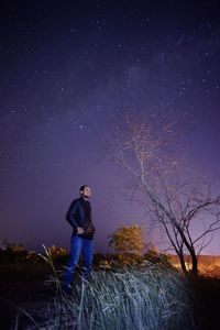 Silhouette of people standing on field at night