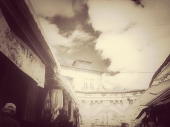 Low angle view of building against cloudy sky