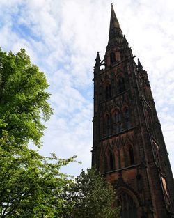 Low angle view of clock tower against sky