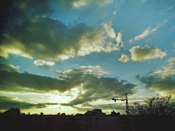 Silhouette landscape against cloudy sky