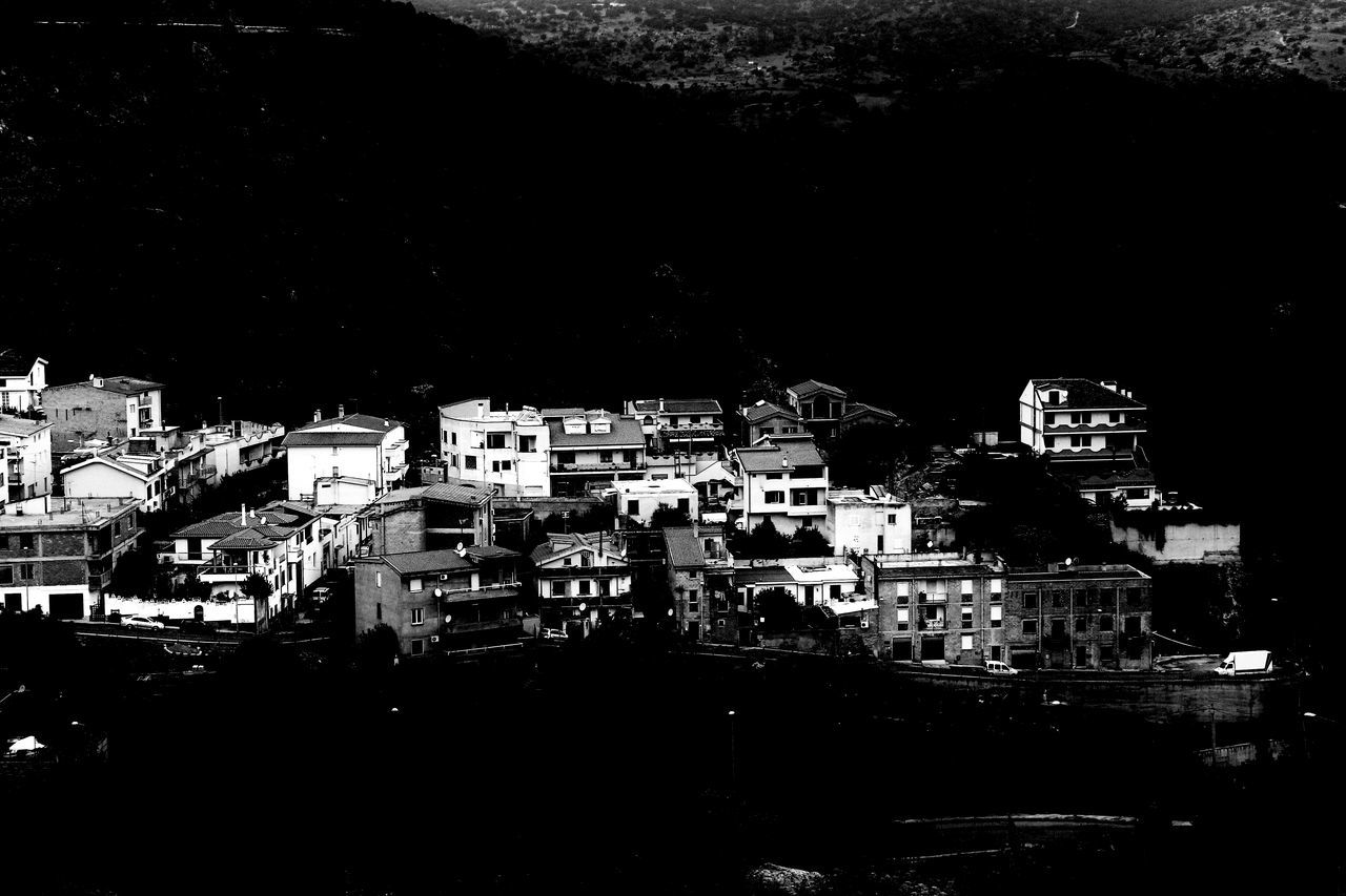 HIGH ANGLE VIEW OF ILLUMINATED BUILDINGS IN CITY