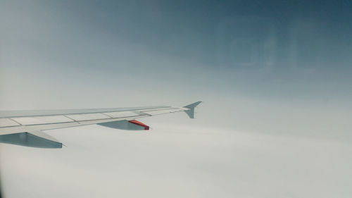 Low angle view of airplane flying against sky