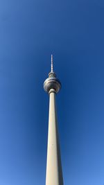 Low angle view of communications tower against sky