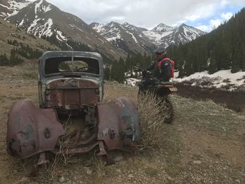 Vintage car on field against mountain range