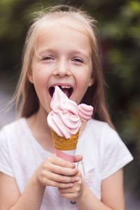 Portrait of smiling young woman eating ice cream