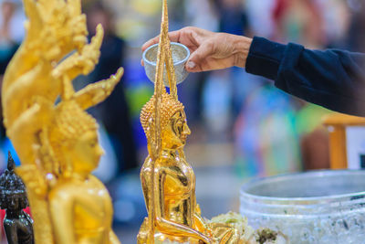 Close-up of hand holding cross at market