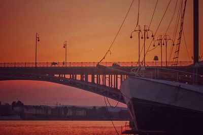 View of bridge over river at sunset