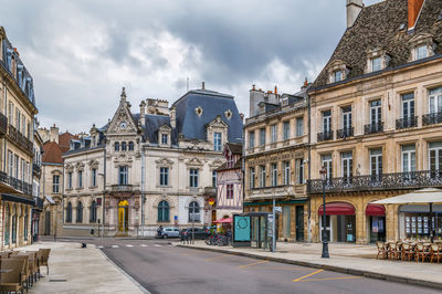 Street amidst buildings in city against sky