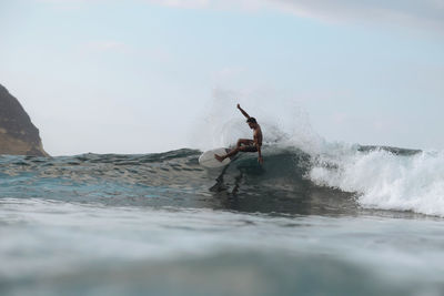 Surfer on a wave, lombok, indonesia