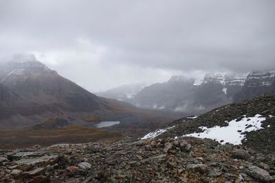 Scenic view of mountains against cloudy sky