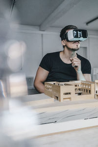 Man with architectural model and vr glasses