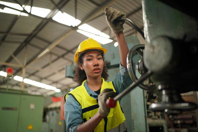 Portrait of young man working in factory