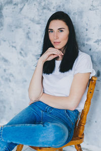 Portrait of beautiful young woman sitting outdoors