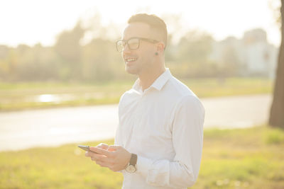 Full length of young man using smart phone