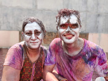 Portrait of happy indian couple celebrating holi with silver paint colorl. indian festival holi.