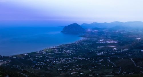 Aerial view of sea and rocks against sky