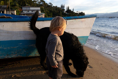 Side view of woman with dog on beach