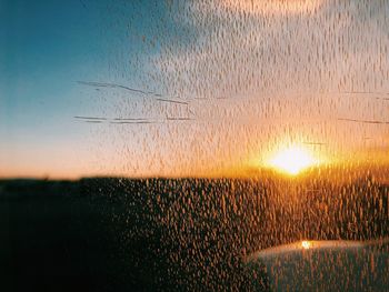 Scenic view of field against sky at sunset
