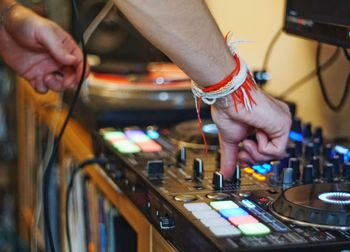 Cropped hand of man mixing music at recording studio