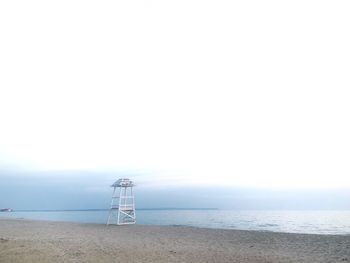 Lifeguard hut on beach against clear sky