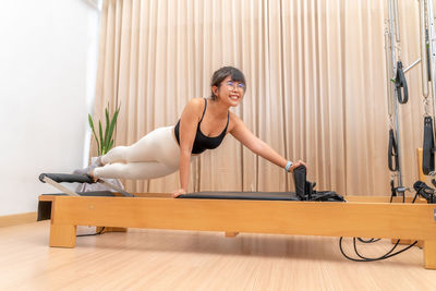 Woman smiling while sitting on wooden floor