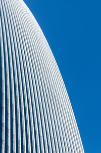 Low angle view of modern building against blue sky