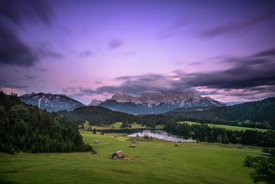 Scenic view of field and mountains against sky