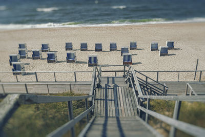 High angle view of deck chairs on beach