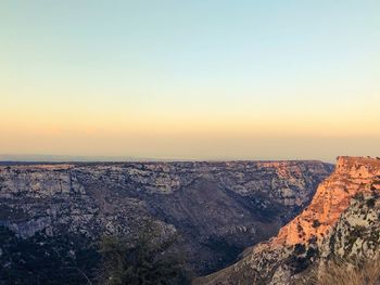 Scenic view of landscape against clear sky during sunset