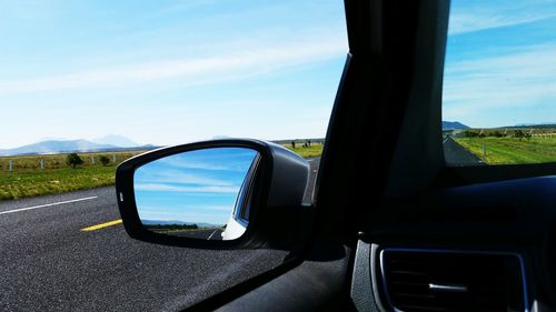 Reflection of car on side-view mirror